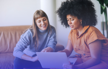 two women working off computer